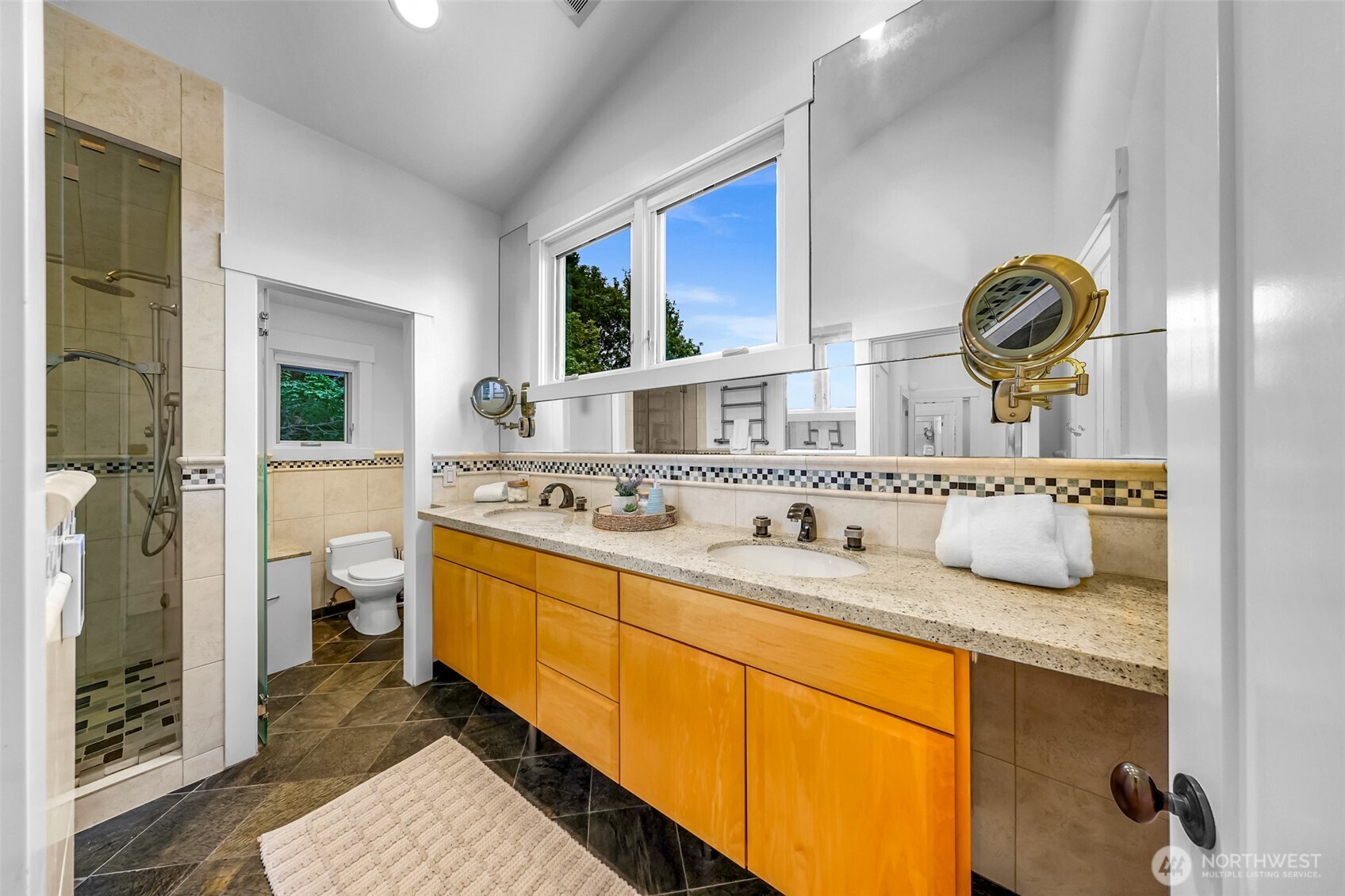 8449 West Mercer Way Mercer Island, WA 98040 - Photo 21 of 40 a bathroom with a granite countertop sink and a mirror