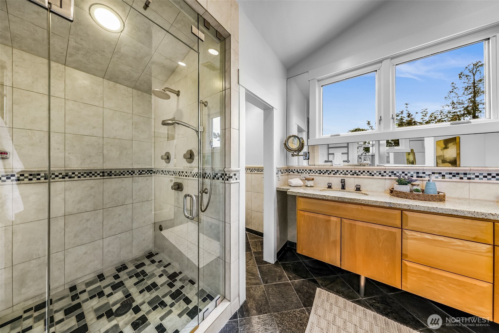 8449 West Mercer Way Mercer Island, WA 98040 - Photo 22 of 40 a bathroom with a sink and a mirror