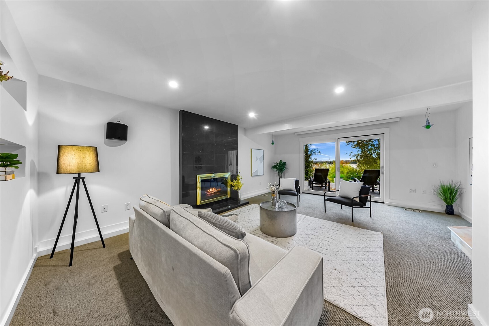 8449 West Mercer Way Mercer Island, WA 98040 - Photo 29 of 40 a living room with furniture a flat screen tv and a lamp