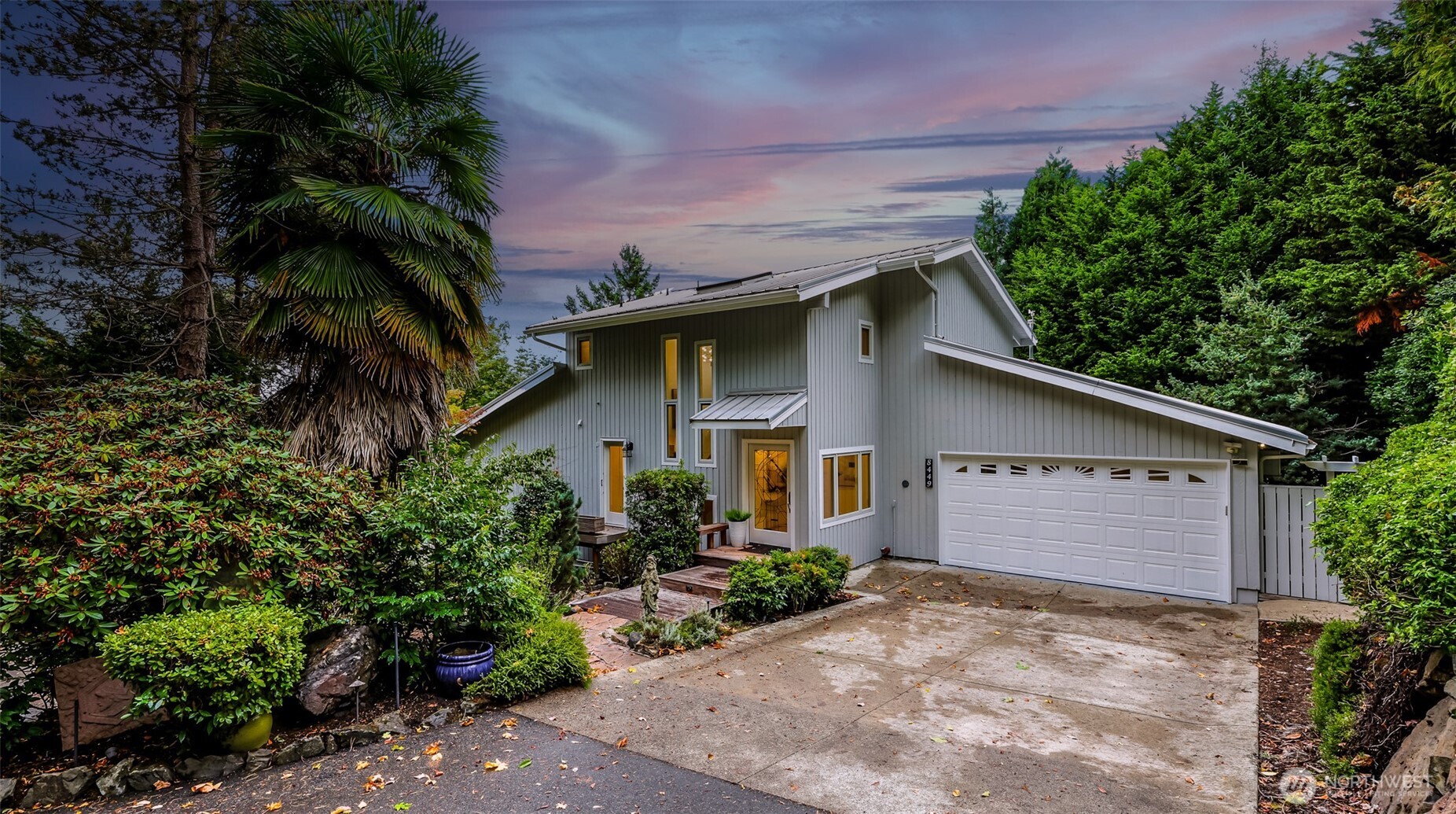 8449 West Mercer Way Mercer Island, WA 98040 - Photo 3 of 40 a front view of a house with a yard