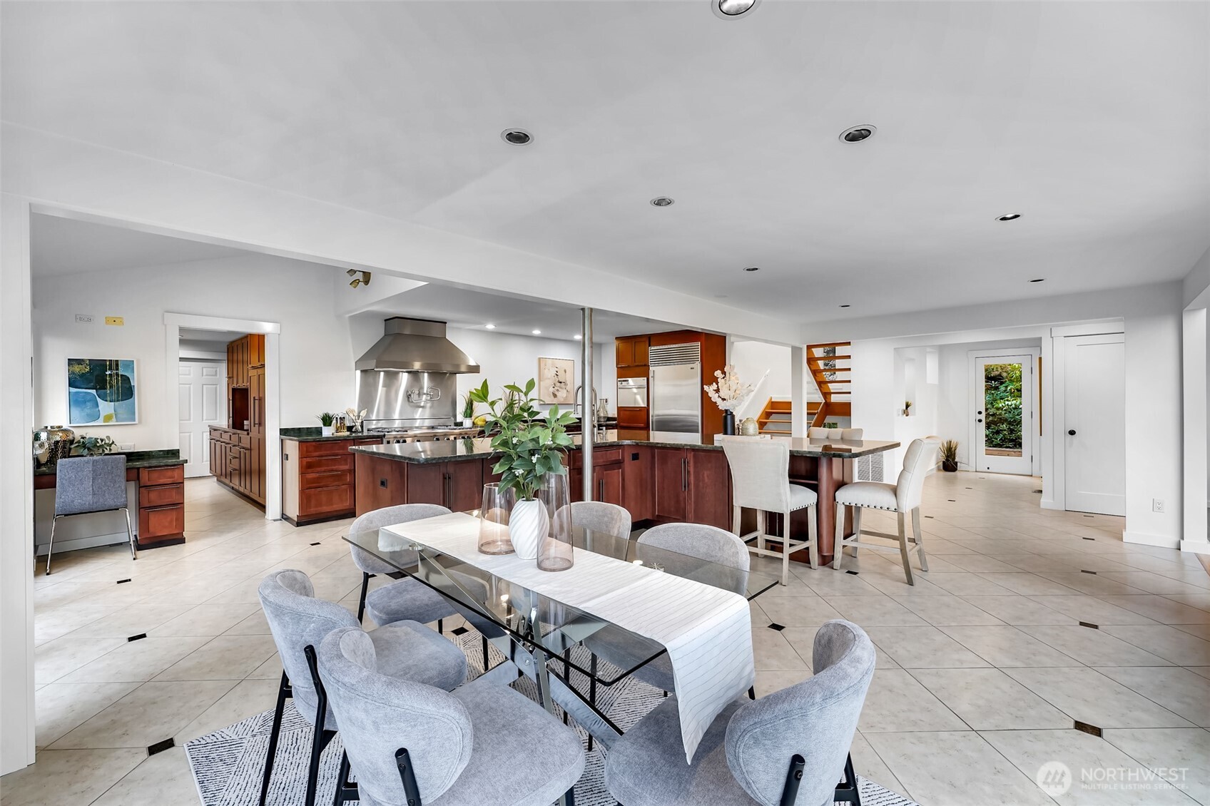 8449 West Mercer Way Mercer Island, WA 98040 - Photo 7 of 40 a living room with furniture and a dining table with potted plants