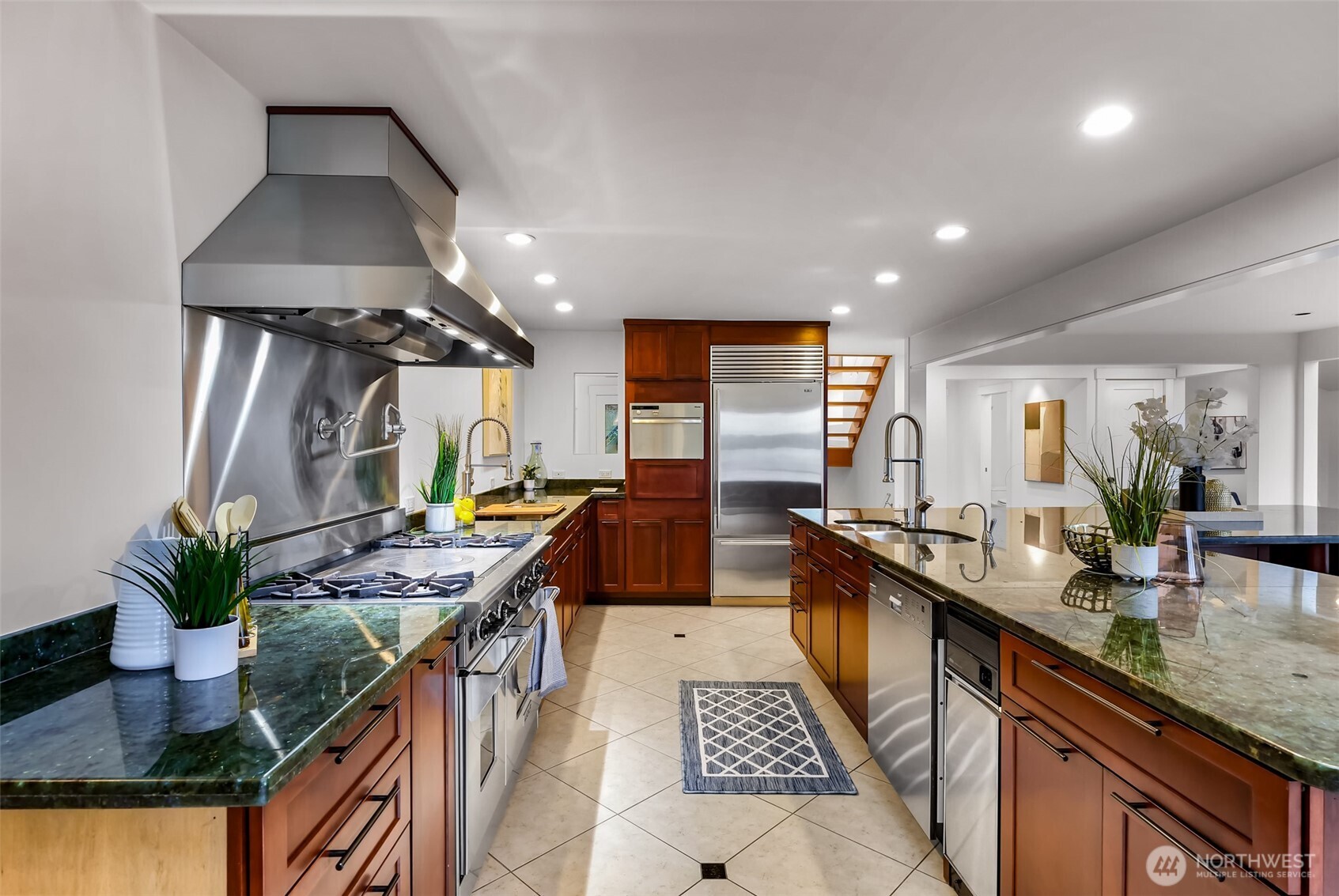 8449 West Mercer Way Mercer Island, WA 98040 - Photo 9 of 40 a kitchen with stainless steel appliances granite countertop a sink a stove and a wooden floors