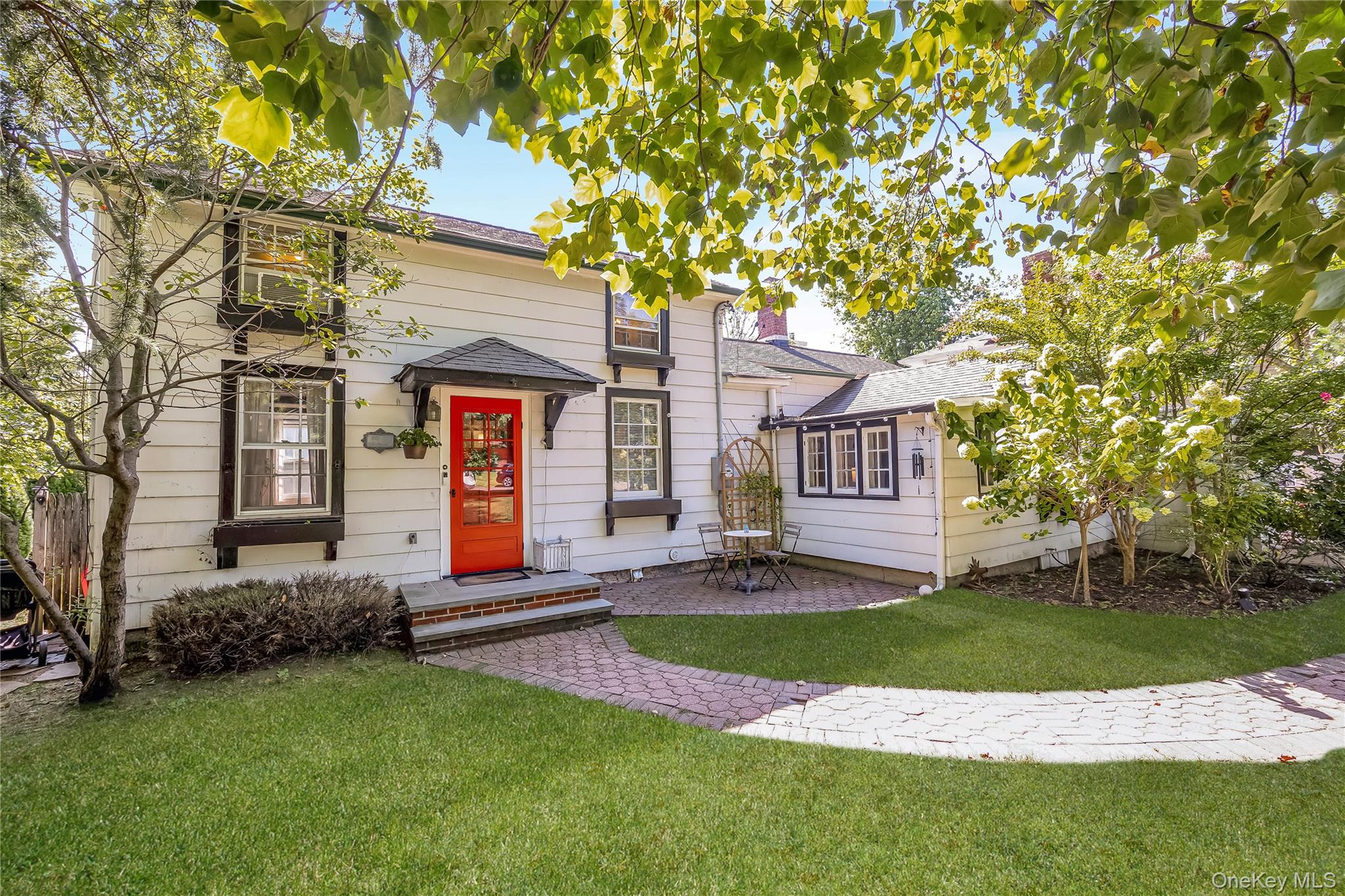 16 Rider Avenue Malverne, NY 11565 - Photo 1 of 1 a front view of a house with a yard and garage
