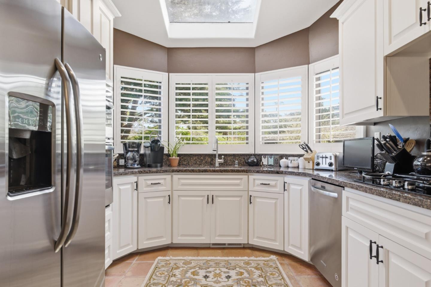 1155 Lookout Road Pebble Beach, CA 93953 - Photo 17 of 33 a kitchen with stainless steel appliances granite countertop a stove a sink and a microwave