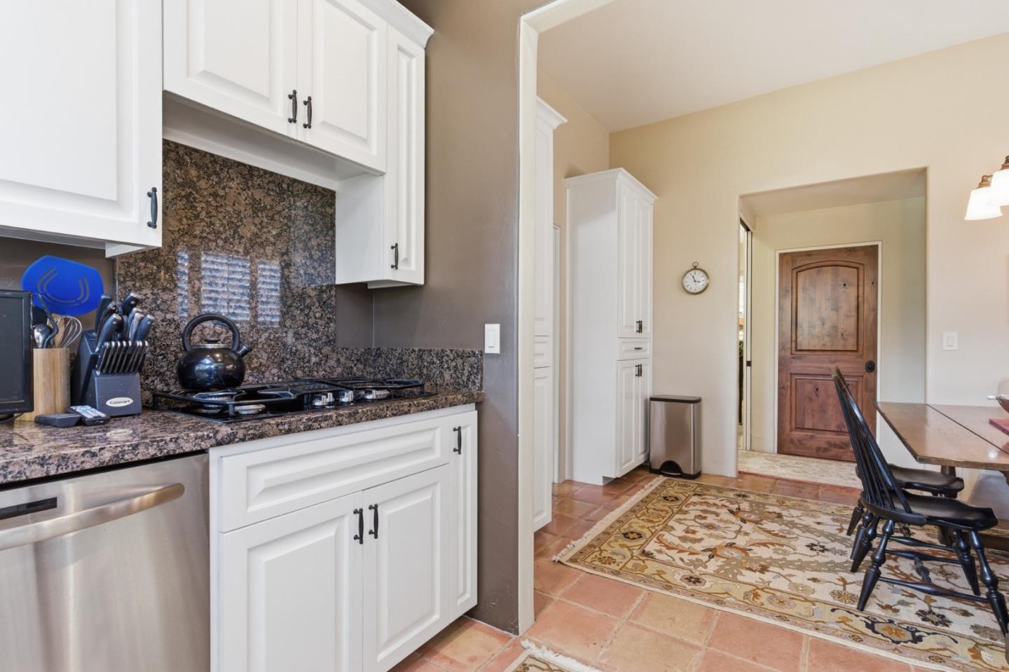 1155 Lookout Road Pebble Beach, CA 93953 - Photo 18 of 33 a kitchen with stainless steel appliances granite countertop a stove refrigerator and cabinets