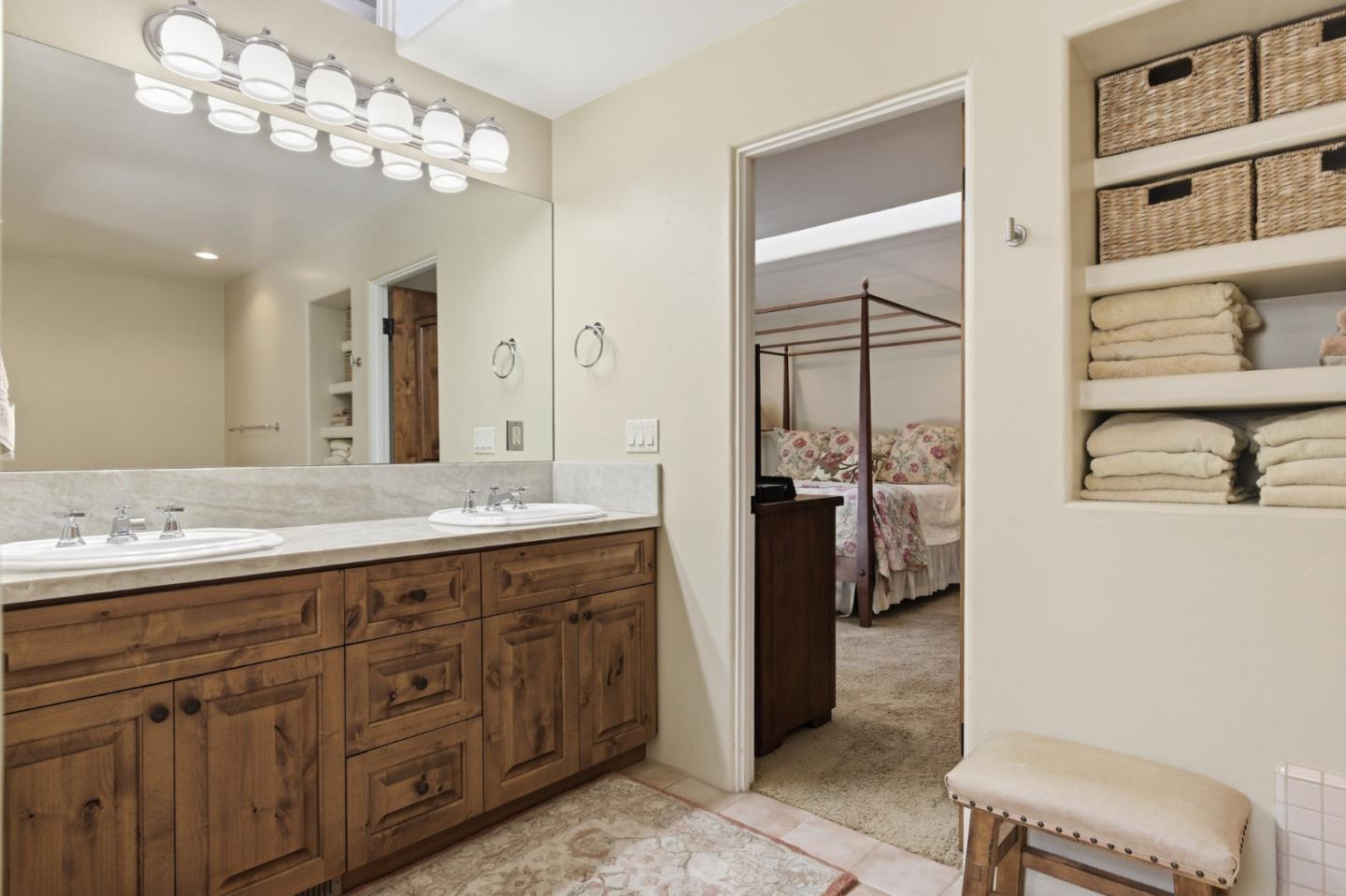 1155 Lookout Road Pebble Beach, CA 93953 - Photo 22 of 33 a bathroom with a double vanity sink and a mirror