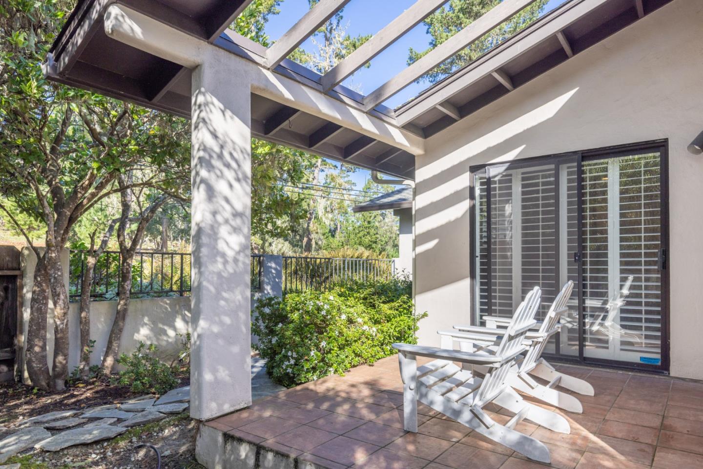 1155 Lookout Road Pebble Beach, CA 93953 - Photo 29 of 33 a view of a patio with table and chairs and potted plants