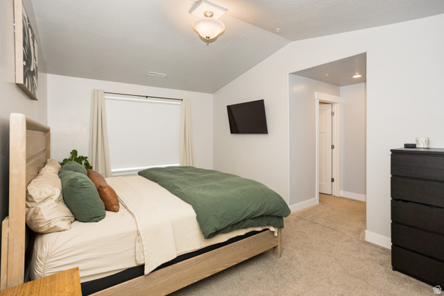 2452 West 500 South, Unit 2 Springville, UT 84663 - Photo 13 of 23 Vaulted ceiling room featuring carpet flooring, a window with roller shade, and a built-in light fixture