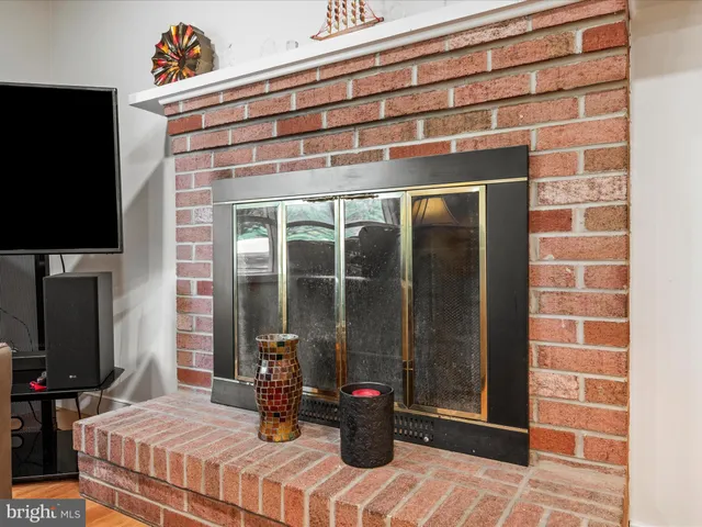 a bedroom with a bed table and flat screen tv