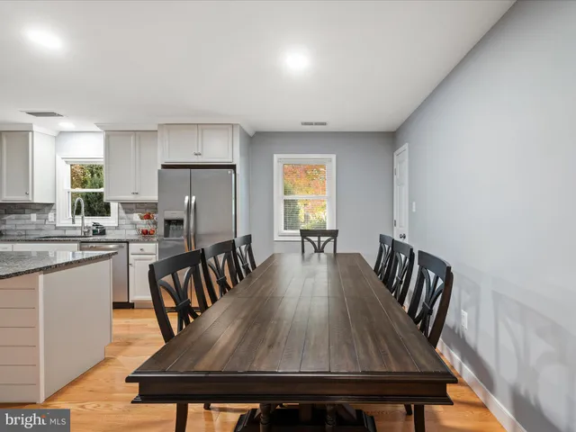 a dining room with furniture and wooden floor