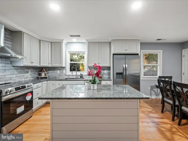 a kitchen with counter space dining table and chairs