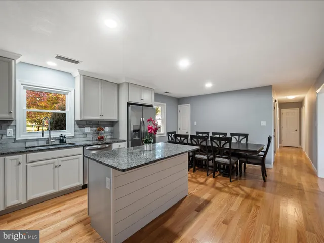 a kitchen with granite countertop a sink and a window