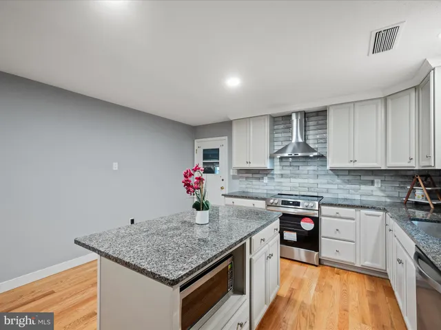 a bedroom with a bed and a night stand