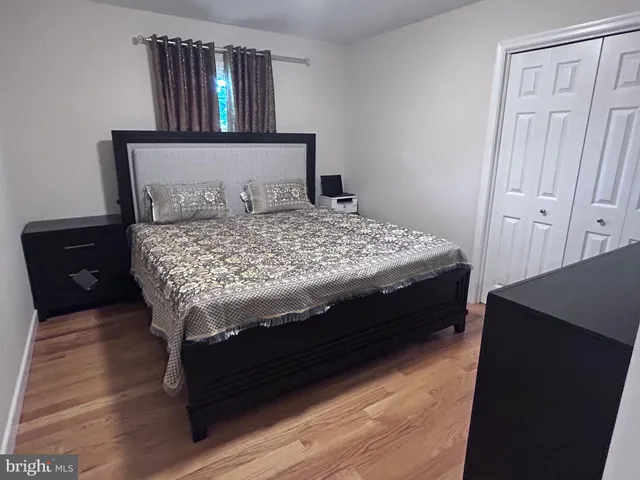 a bedroom with a bed and a dresser