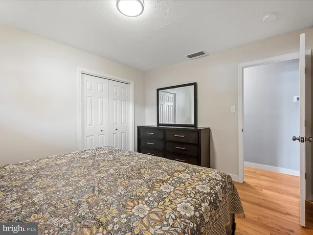 a bathroom with a granite countertop toilet sink and mirror