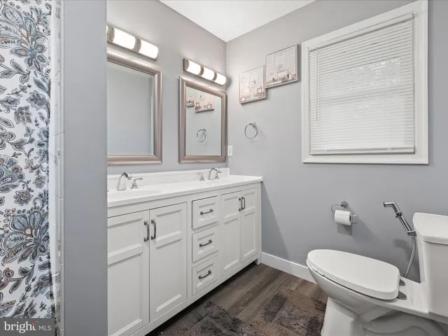 a bathroom with a sink a vanity and a mirror