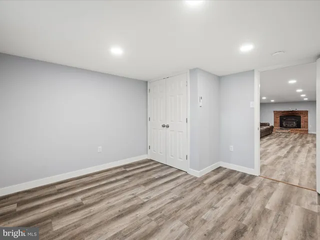 a bedroom with a bed and a night stand