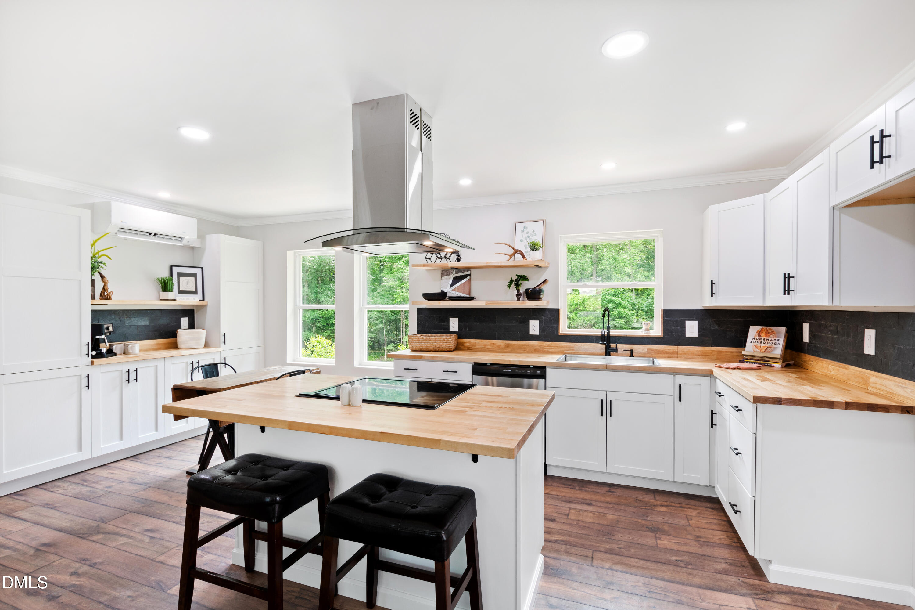 2153 Hurdle Mills Road Roxboro, NC 27574 - Photo 14 of 32 a kitchen with a table chairs sink and cabinets