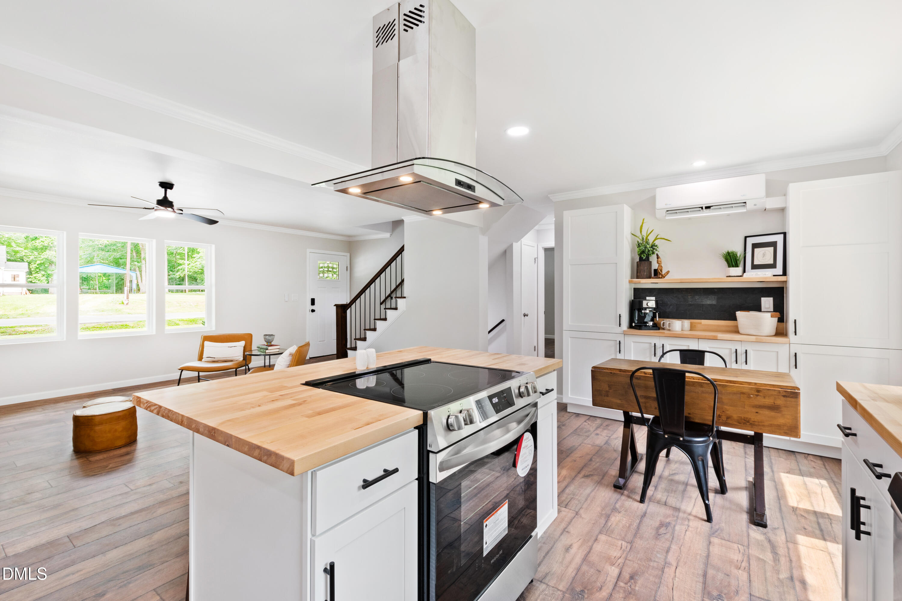 2153 Hurdle Mills Road Roxboro, NC 27574 - Photo 15 of 32 a kitchen that has a lot of cabinets a sink and wooden floor