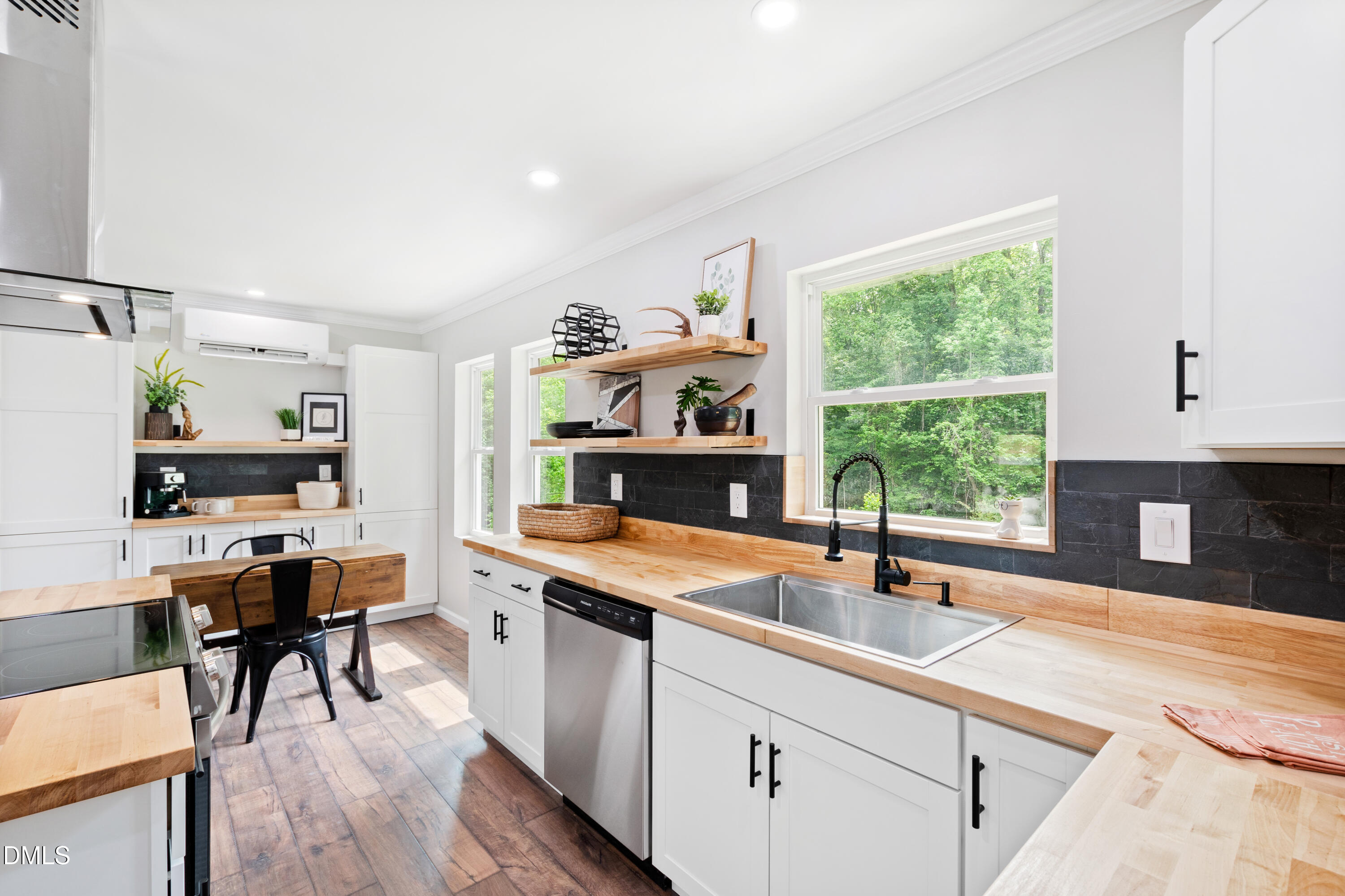 2153 Hurdle Mills Road Roxboro, NC 27574 - Photo 16 of 32 a kitchen with a sink a window and chairs