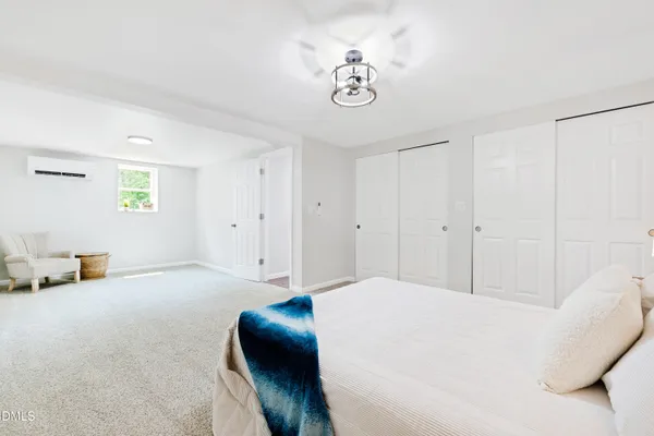 a bedroom with a bed and window