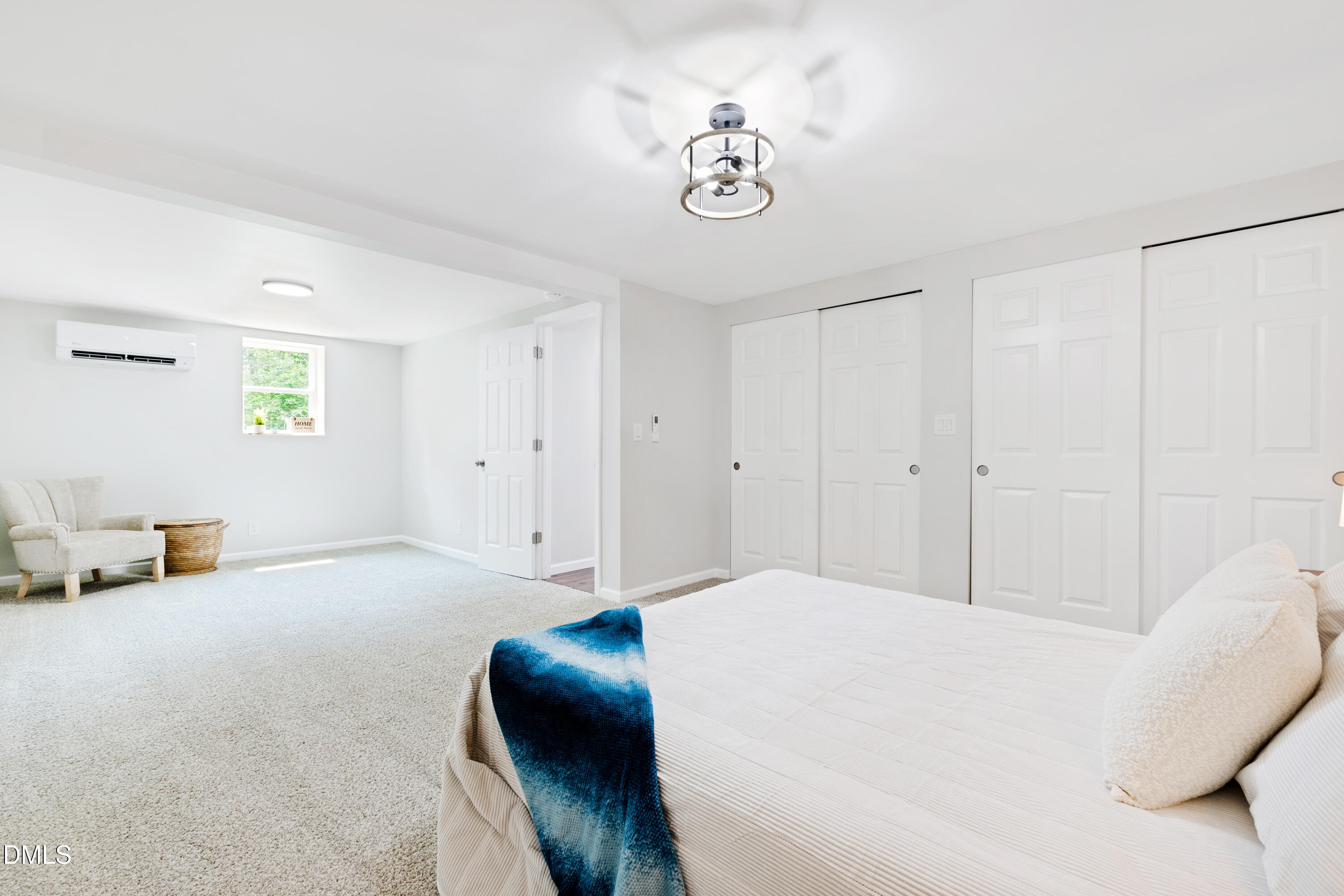 2153 Hurdle Mills Road Roxboro, NC 27574 - Photo 24 of 32 a bedroom with a bed and a chandelier