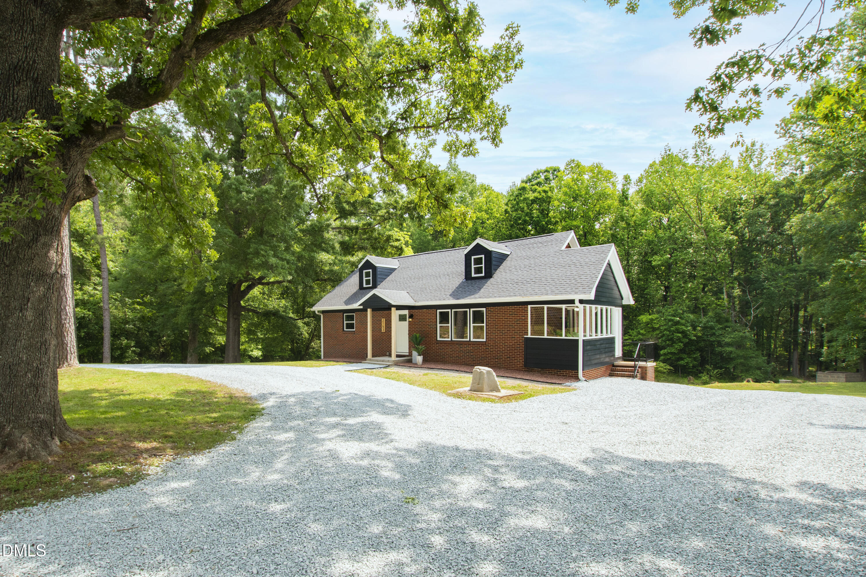 2153 Hurdle Mills Road Roxboro, NC 27574 - Photo 2 of 32 a view of a house with a big yard and large trees