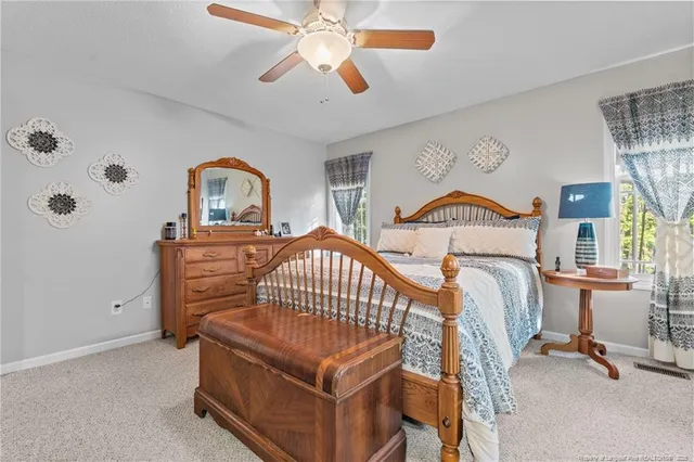 a bedroom with furniture window and a ceiling fan