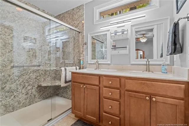 a bathroom with a granite countertop sink mirror and bathtub