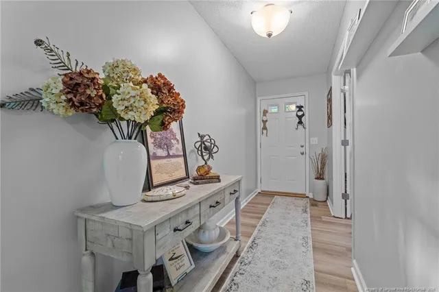 a front view of a house with a garden and trees