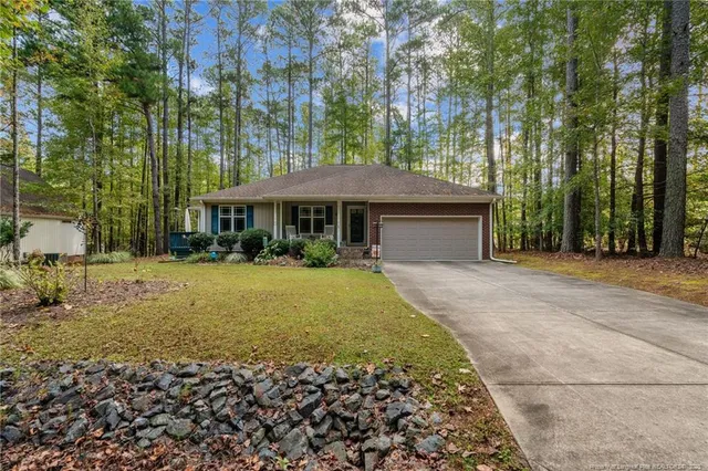 a view of a house with backyard porch and sitting area