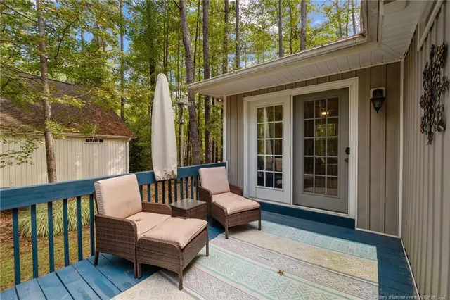 a view of a chair and tables in the balcony