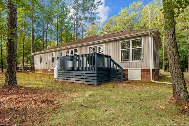 a view of outdoor space with deck and yard