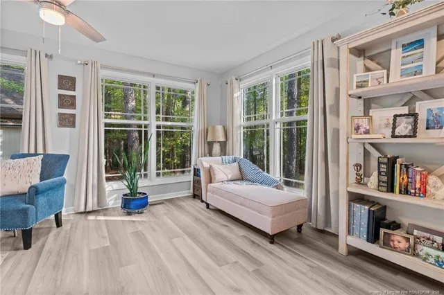 a bedroom with a bed and a large window with the outer view