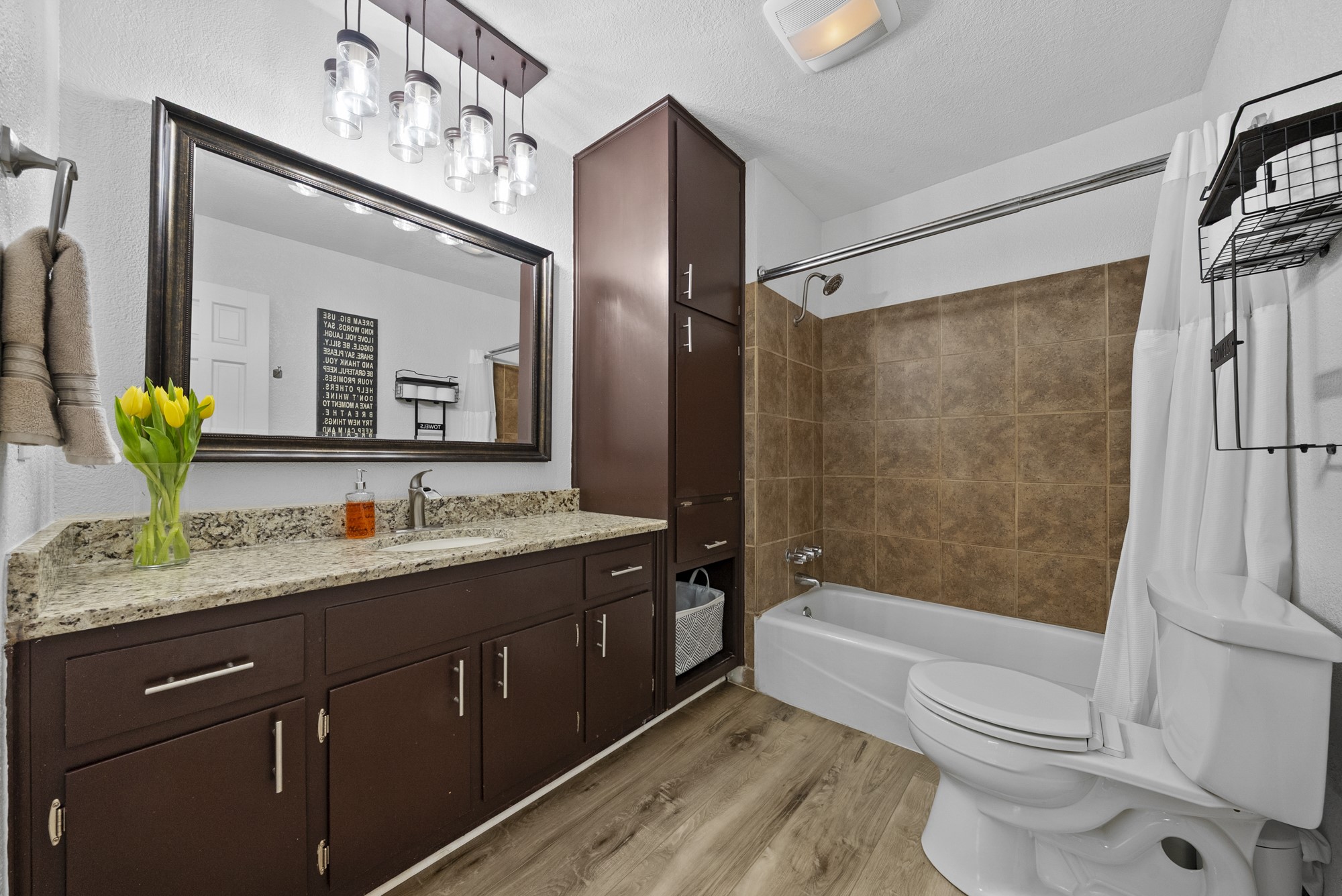 2802 Robin Road Manchaca, TX 78652 - Photo 34 of 40 Bathroom featuring a dark wood-finish vanity with a light speckled countertop and undermount sink