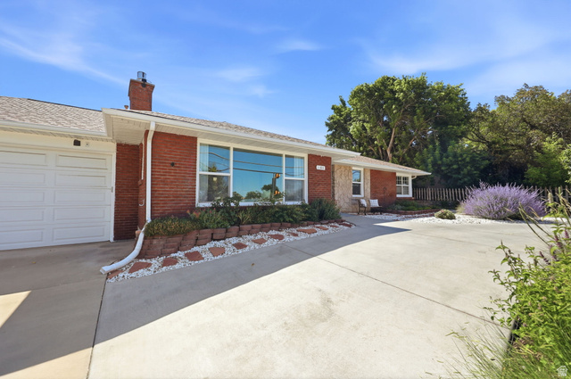1180 North 400 East Bountiful, UT 84010 - Photo 9 of 50 Red brick exterior with a single garage door