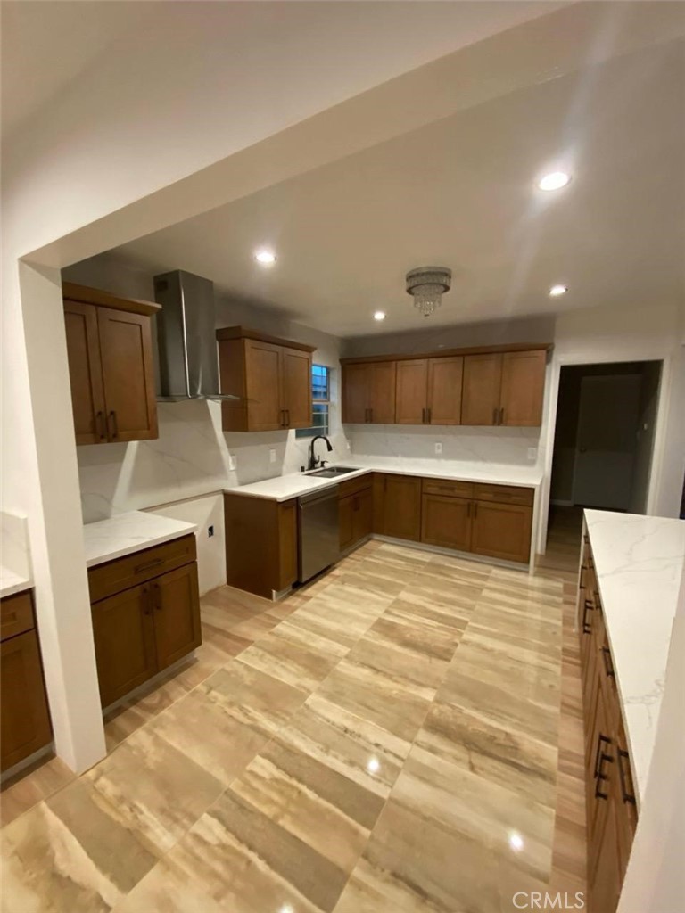 307 North Broadacres Avenue Compton, CA 90220 - Photo 5 of 13 a large white kitchen with a sink a microwave and refrigerator