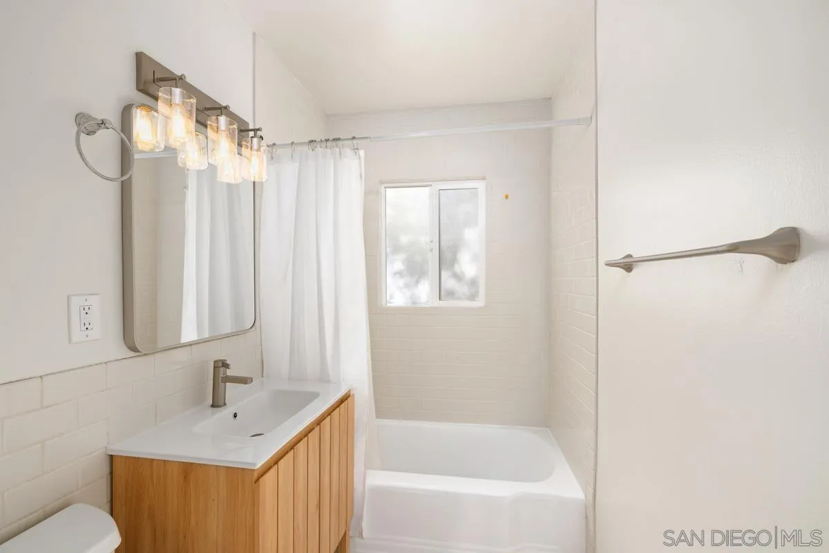 5826 Amarillo Avenue La Mesa, CA 91942 - Photo 12 of 20 a bathroom with a shower curtain and a sink