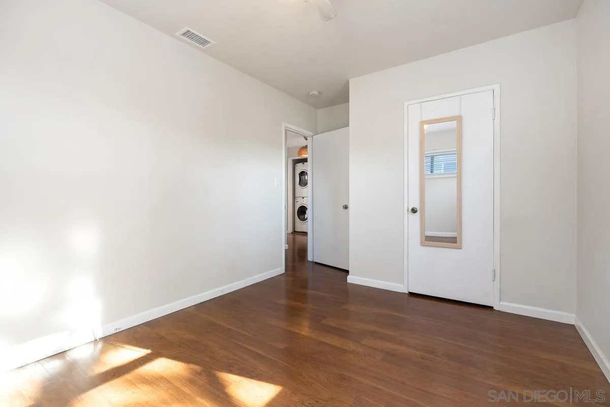 5826 Amarillo Avenue La Mesa, CA 91942 - Photo 14 of 20 an empty room with wooden floor and closet