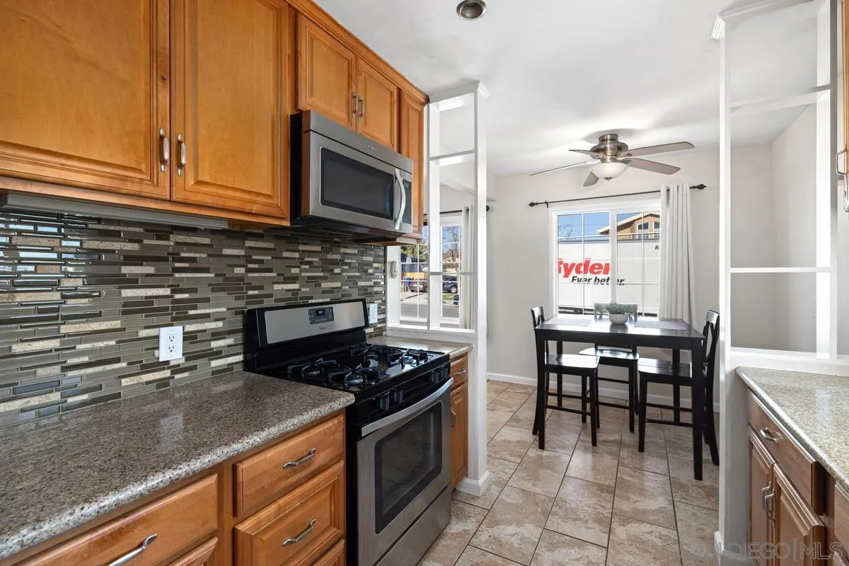 5826 Amarillo Avenue La Mesa, CA 91942 - Photo 2 of 20 a kitchen with stainless steel appliances granite countertop a stove a sink and a microwave