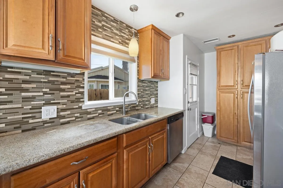 5826 Amarillo Avenue La Mesa, CA 91942 - Photo 4 of 20 a kitchen with stainless steel appliances granite countertop a sink and a refrigerator
