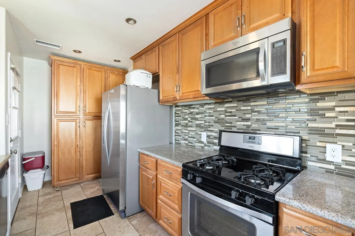5826 Amarillo Avenue La Mesa, CA 91942 - Photo 5 of 20 a kitchen with stainless steel appliances granite countertop a stove and a microwave