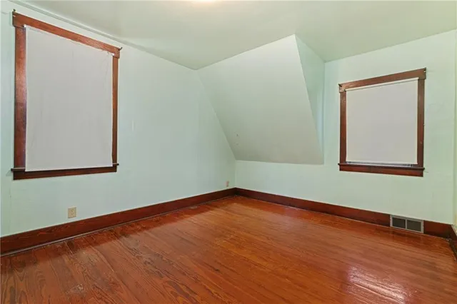a view of a room with wooden floor and white walls