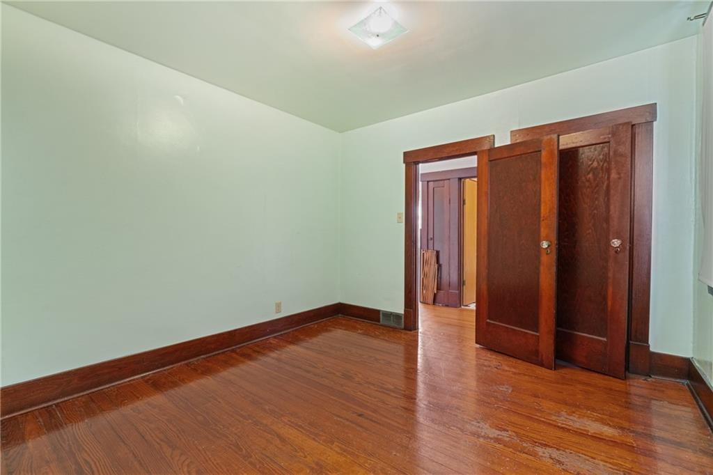 767 Fellsburg Road Belle Vernon, PA 15012 - Photo 22 of 30 a view of an empty room with wooden floor and closet
