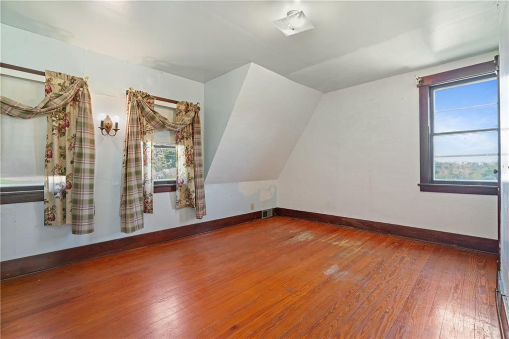 767 Fellsburg Road Belle Vernon, PA 15012 - Photo 24 of 30 a view of an empty room with window and wooden floor