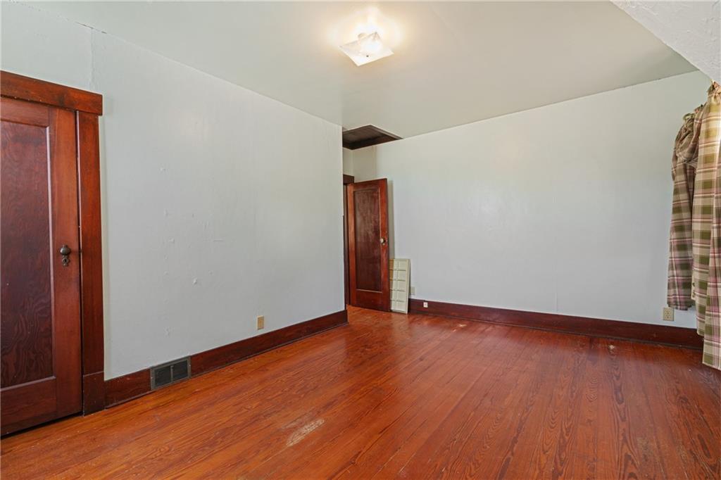 767 Fellsburg Road Belle Vernon, PA 15012 - Photo 25 of 30 a view of an empty room with wooden floor and a window
