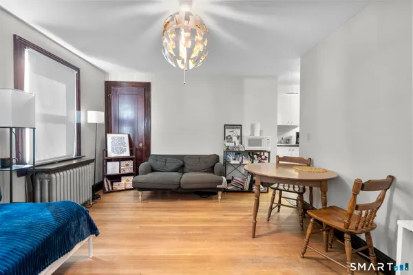 a view of a workspace with furniture and a window