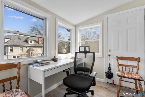 a dining room with furniture window and wooden floor