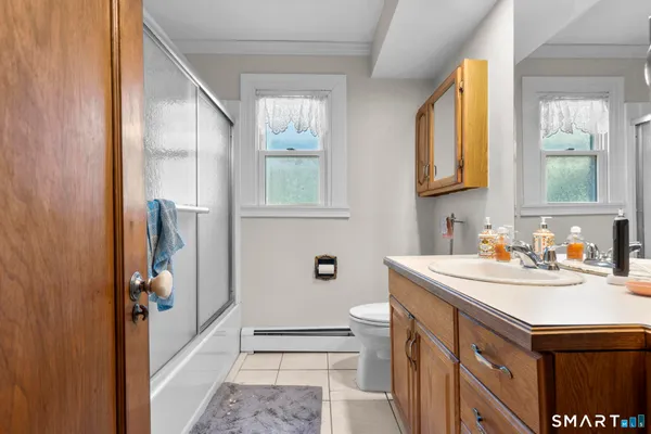 a bathroom with a sink a toilet and a window