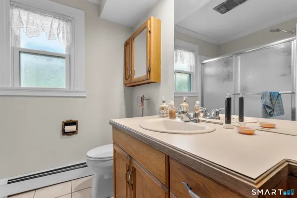 a bathroom with a sink a toilet and a mirror